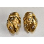 A pair of diamond set clip on earrings, textured three section curled 18ct yellow gold body,