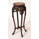 A Chinese padouk wood jardiniere stand,