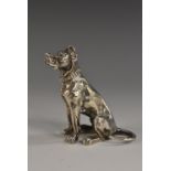 An early 20th century silver novelty canine model, cast as a Doberman type dog, seated, 6cm high,