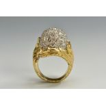 A neoclassical diamond ring, domed white crest inset with approx fifty round brilliant cut diamonds,