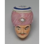 An early 19th century English porcelain novelty bonbonnière, the toy modelled as the head of a Turk,