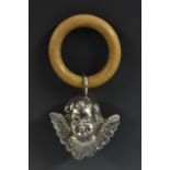 A late 19th century silver coloured metal novelty baby's rattle, as a Reynolds Angel, 10.