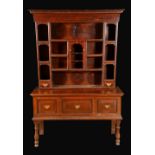 An '18th century' oak dresser, dentil cornice above an arrangement of shelves,