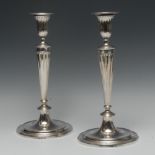 A pair of George III Neo-Classical cast silver table candlesticks,