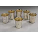 A set of six George III style silver flared cylindrical beakers, crest, 8.