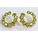 A pair of vibrant green peridot and diamond earrings,