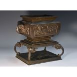 A Japanese dark patinated bronze rectangular koro, the sides cast in relief with blossoming prunus,