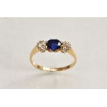 A sapphire and diamond trilogy ring, central oval cushion cut blue sapphire, approx 0.