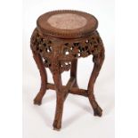 A Chinese hardwood jardiniere stand, circular top with inset soapstone panel,