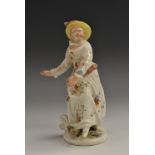 A Bow figure, of Columbine from the Commedia dell'Arte, holding a slapstick,