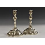 A pair of 18th century German Rococo silver table candlesticks,