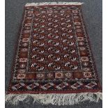 An Afghan wool and silk Bukhara rug, the field worked with geometric motifs,