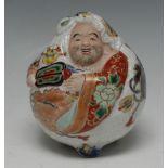 A Japanese Satsuma porcelaineous novelty, of a comical figure, painted in colourful polychrome,