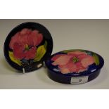 A Moorcroft Magnolia pattern trinket pot and cover;