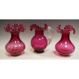 A pair of Victorian cranberry glass wrythen ovoid vases, wavy everted rims, 20cm high, c.