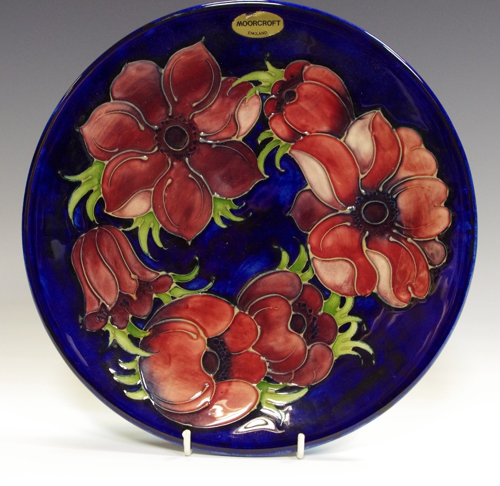 A Moorcroft poppy pattern cabinet plate, tube lined,