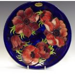 A Moorcroft poppy pattern cabinet plate, tube lined,