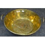A large two handled copper pan with brass washed interior