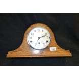 An early 20th century oak Napoleon mantel clock,