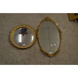 A Louis XVI style oval gilt mirror;
