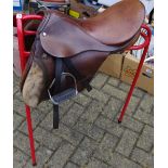 Stubben riding equipment saddle, with metal tripod stand.