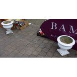 A pair of white painted reconstituted stone urn planters (faults)