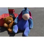 A large Disney Eyore soft toy;