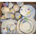 An early 20th century ten-setting tea service, boldly painted with tulips in tones of purple,