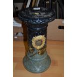 An early 20th century jardiniere stand, in relief with sunflowers; another,