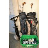 A golf trolley; an Alantic golf bag; another, various golf balls,