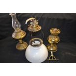 A brass oil lamp, opaque white glass shade,