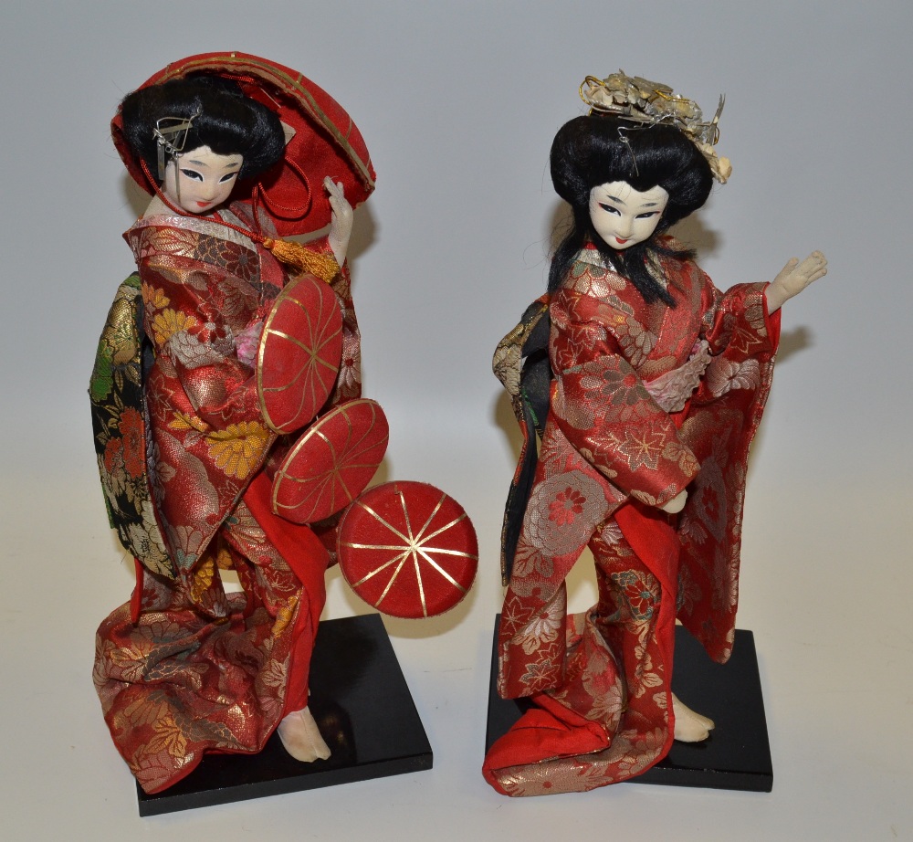 A pair of Japanese Geisha girls, wearing red,