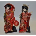 A pair of Japanese Geisha girls, wearing red,