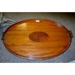 An Edwardian mahogany two-handle serving tray, the field with oval patera,