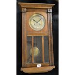 Clocks - A 1930's oak wall hanging 8-day clock **All lots in this sale are subject to a maximum of