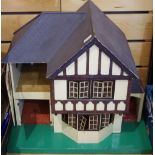 A mid 20th century dolls house in the Tudor style, opening front.