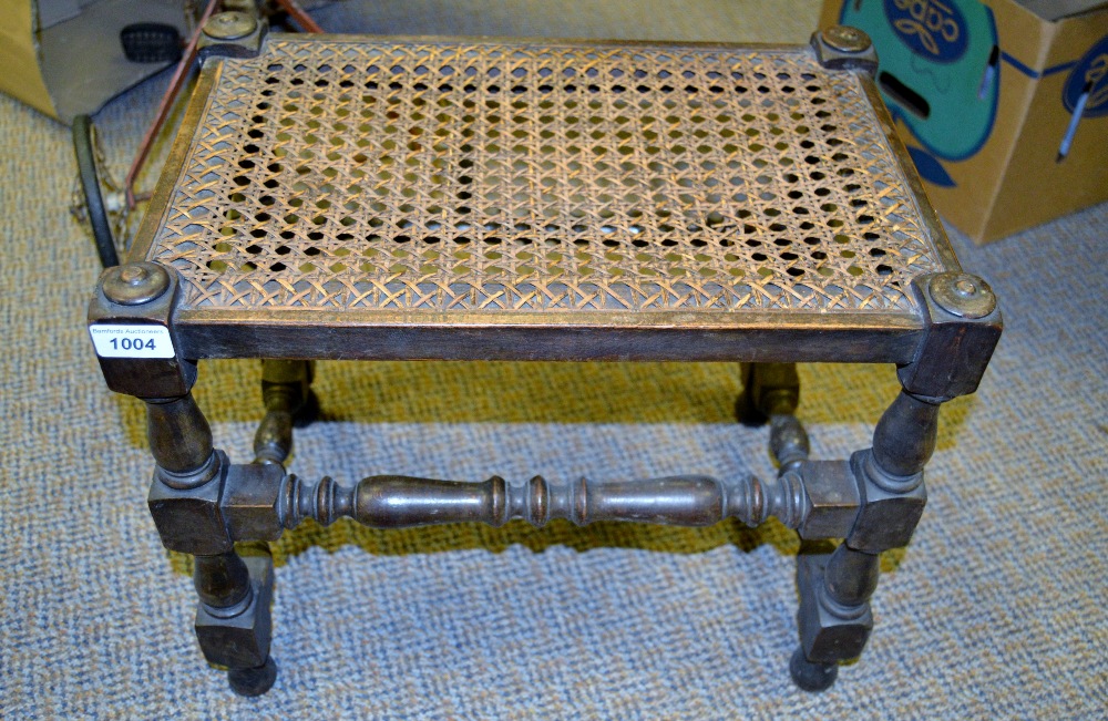 An early 20th century rectangular stool, bergere top, turned legs and stretchers, 45cm wide, c.