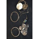 A Mexican silver charm bracelet, stamped 925; a silver hinged bangle, hallmarked; another,