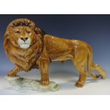 A substantial Goebel lion stood on a rocky outcrop,
