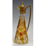 A Bohemian spreading hexagonal claret jug, overlaid in amber glass and engraved with foliage,