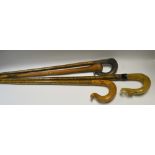A horn handled walking stick/crook; others, olive handled,