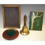 A brass school bell; a school child's slate; a pocket change tray; a book,