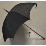 A late 19th century parasol, shot black taffeta with hardwood root handle, brass tip, c.