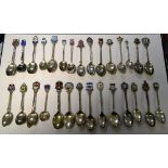 A quantity of silver, white metal and enamelled souvenir spoons, including David Andersen,