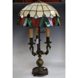 A Tiffany style table lamp, trefil support with swans.