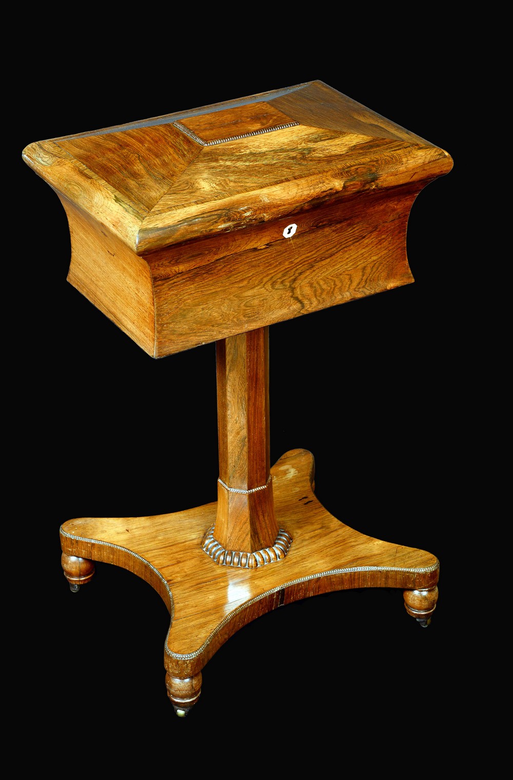 A George/William IV rosewood sarcophagus teapoy, hinged cover, panelled column, fluted socle,