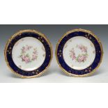 A pair of Royal Crown Derby shaped circular plates, painted by Charles Harris, one signed CH,