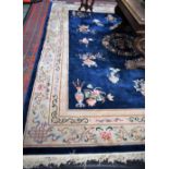 A Chinese style carpet, on a midnight blue ground,
