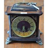 An Odo bracket style mantel clock, brass dial, twin winding holes, Roman and Arabic numerals,