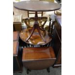 A mahogany oval nest of three tables; a mahogany dropleaf occasional table;